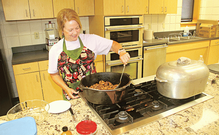 Michelle Brown browns the meat for the “CFMA Stew” during a cooking demonstration Thursday at LSUE. The pork stew was prepared for a networking session of the St. Landry Parish Tourism Commission. (Photos by Harlan Kirgan)