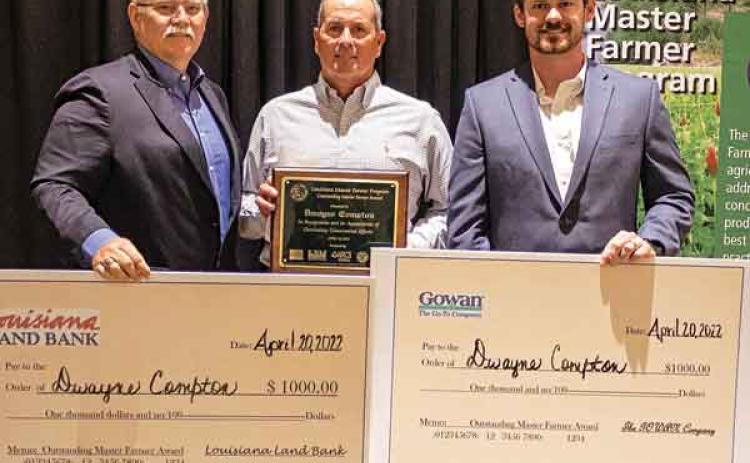 Dwayne Compton, of Jefferson Davis Parish, was named the 2021 Outstanding Master Farmer. He is pictured with Stephen Austin from Louisiana Land Bank and Eric Bergeron with the Gowan Company, who each presented him with a check for $1,000. (Photo by V. Todd Miller/LSU AgCenter)