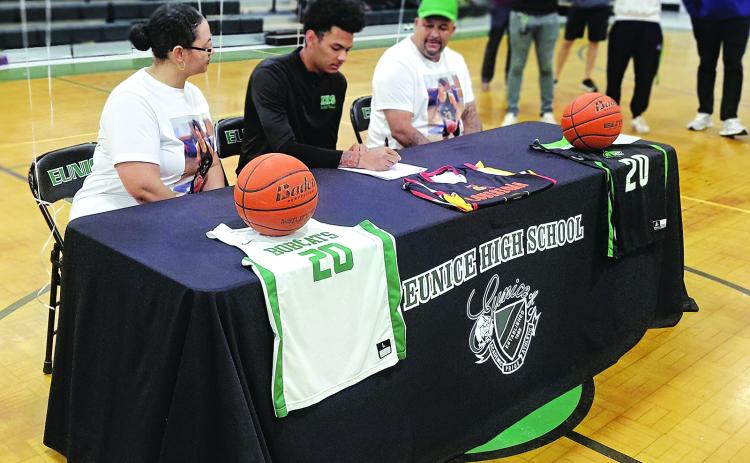 Eunice High senior DeAndre Reed signs on the dotted line to play at Community Christian College in Lafayette on Monday afternoon.