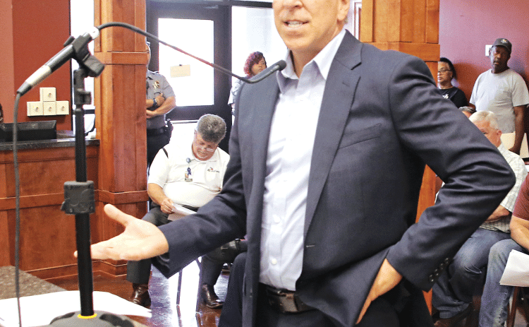 Steve Moosa, CPA, of Darnall, Sikes & Frederick, delivers a report on adjudicated property sales at the St. Landry Parish Council meeting on May 3. (Photo by Harlan Kirgan)