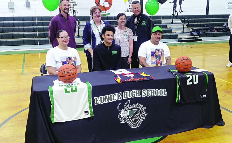 Eunice High senior DeAndre Reed is all smiles after signing a Letter of intent to play at Lafayette’s Community Christian College. He is pictured with his parents and Eunice High administrators Chad Andrepont, Irma Trosclair, Rachel Smith and Dexter Brown. (Photo by Rhett Manuel)