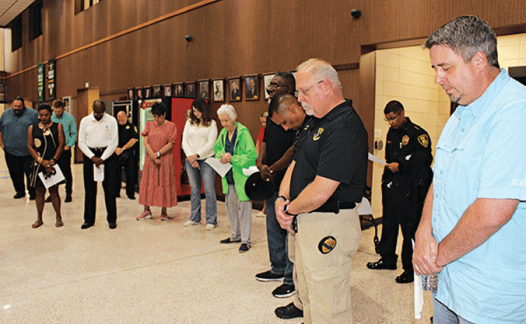 Despite rain at noon on Thursday the National Day of Prayer was observed inside the lobby of the City Hall. Several people attended the prayer event led by Eunice ministers. Mayor Scott Fontenot, right, welcomed the group to City Hall. Standing next to the mayor is Police Chief Kyle LeBouef. (Photo by Myra Miller)