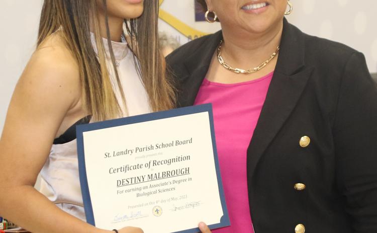 Destiny Malbrough, of Eunice High School, is one of 15 St. Landry Parish students who are scheduled to received associate degrees from LSU Eunice on May 19, which is the same day she graduates for high school. With Malbrough is interim St. Landry Parish Superintendent Dwanetta Scott at the May 4 School Board meeting. The 15 St. Landry Parish public school students receiving associate degrees at LSUE is a record for the parish. (Photo by Harlan Kirgan)