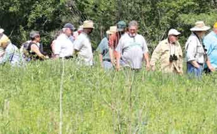 Participants in the Cajun Prairie Habitat Preservation Society’s May meeting are shown at the Eunice site. The society plans its fall meeting this Saturday beginning at its Duralde site at 8 a.m. (Photo by Harlan Kirgan)