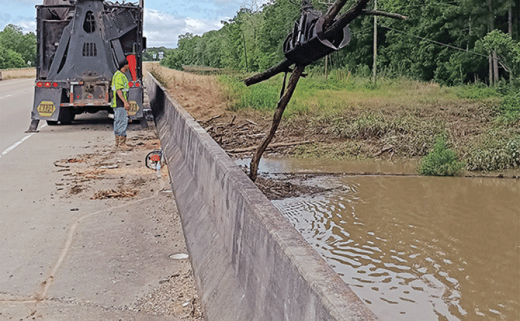 Debris was removed from Bayou Des Cannes on Monday and Tuesday by St. Landry Parish Government crews. Parish Council member Ernest Blanchard said three truck loads of debris were removed and the job is not done. The photo was taken on U.S. 190 west of Eunice. (Submitted photo)