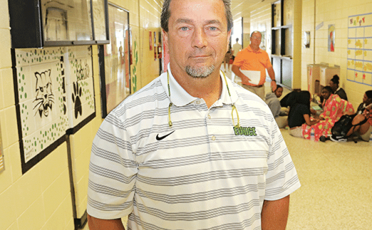 Eunice High School Principal Mitch Fontenot is in the front hall of the school in this photo from 2018. Fontenot plans to retire from Eunice High in June. He said he will continue his career as principal at St. Edmund High School. (Photo by Harlan Kirgan)