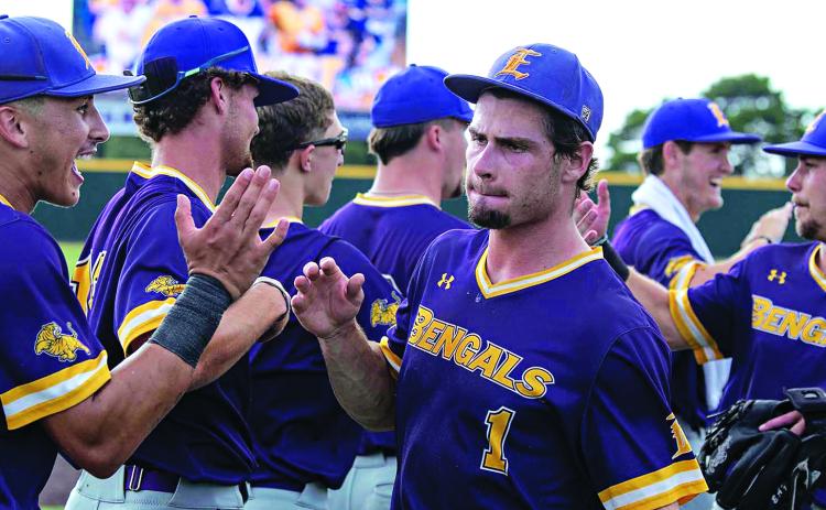 Aidan Mouton (center) celebrates winning the South District Series Championship with Tyler Mitchell (left) and teammates. (Photo by Travis Webb)