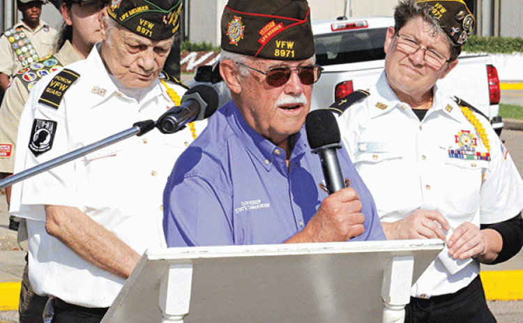 VFW State Commander Don Reber, center, spoke about remembering those who died in service to the nation at the Eunice Memorial Day ceremony. VFW members show are Donald Estillete, left, and Christine Chataignier. (Photos by Harlan Kirgan)