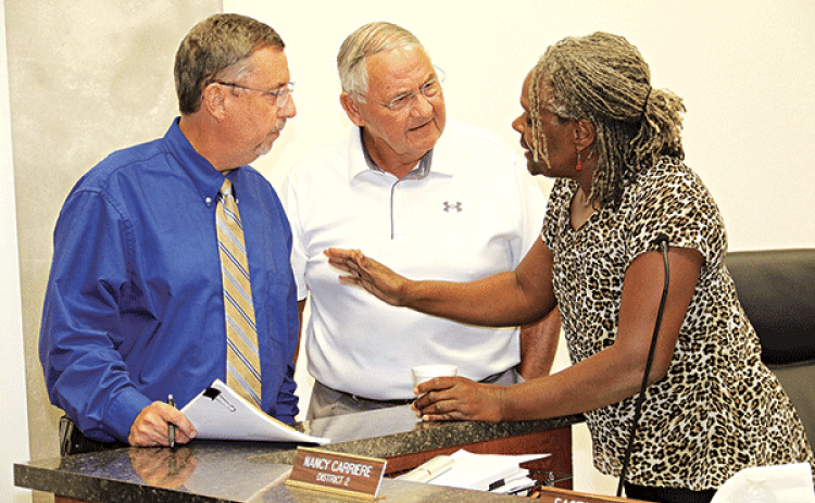 St. Landry Parish Council member Nancy Carriere, right, became a peacemaker after a heated exchange between Parish President Jessie Bellard and Council member Harold Taylor at Wednesday’s meeting in Opelousas. (Photo by Harlan Kirgan)