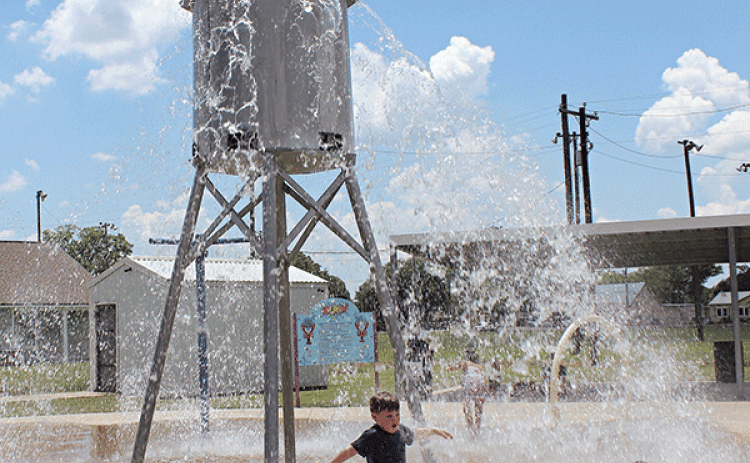 Wyatt Fink, 5, cools off at the Splash Pad at the Fairgrounds on Thursday afternoon. Children are nowing enjoying their summer by cooling off at the splash pad. The splash pad is opened every day from 10 a.m. to 6 p.m. Another splash pad is located directly behind Central Middle School. (Photo by Myra Miller)
