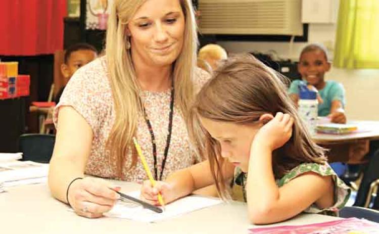 Glendale Elementary teacher Keesha Huval assists Zailynne Taylor during a Camp Accelerate class on Tuesday. (Photos by Harlan Kirgan)