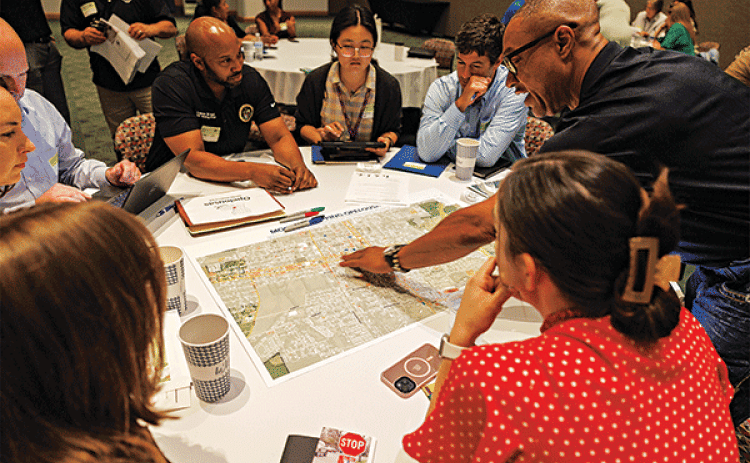 Community leaders from Opelousas mark key locations of the city on a map to assess where sidewalks, crosswalks and bike paths are most needed at the 2024 Louisiana Rural Complete Streets Summit. (Photo by V. Todd Miller/LSU AgCenter)