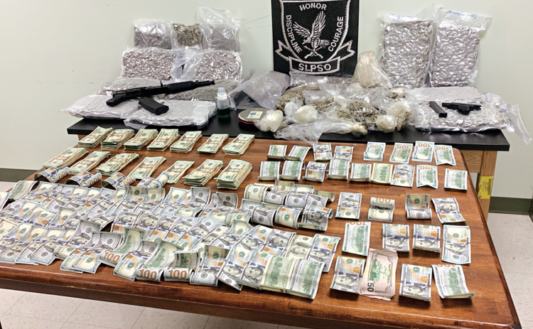 The St. Landry Parish Sheriff's Office released this photo of seized cash, drugs and guns.