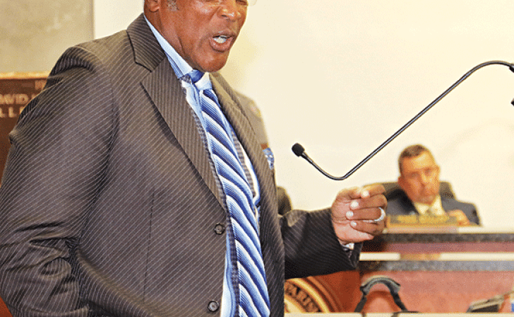 The Rev. Kerney Thomas speaks at Wednesday’s St. Landry Parish Council meeting. In the background is Parish President Jessie Bellard. (Photo by Harlan Kirgan)