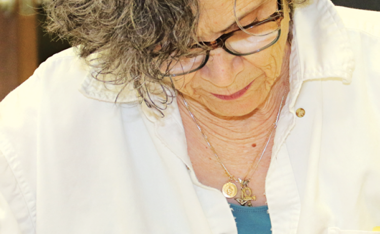 St. Landry Parish School Board member Mary Ellen Donatto looks over a budget document at a meeting Monday in Opelousas. (Photo by Harlan Kirgan)