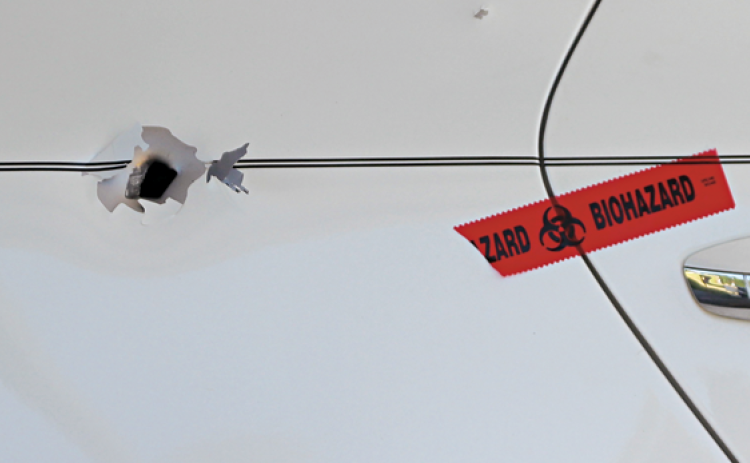 Bullet holes are visible in the car shot Thursday night.