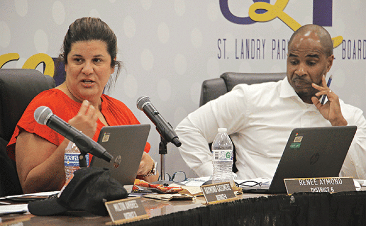 St. Landry Parish School Board member Renee Aymond and Superintendent Milton Batiste III at Tuesday’s Board meeting. Aymond is discussing a $1,000 across-the-board pay raise for employees. (Photo by Harlan Kirgan)