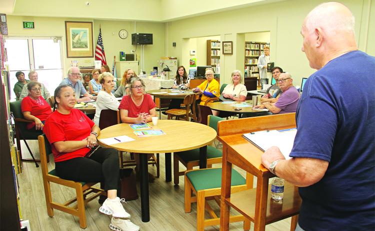 Tony Baltakis, right, president of the Eunice Library Board of Control, beings a meeting to organize a Eunice Friends of the Library on Thursday. The group is formed to become a fundraising arm of the library. The meeting also included electing officers. They are, in the photo at right, and from left, April DeRouen, vice president; Kyle Huval, president; Patina Mitchell, treasurer; and Roxanne Jordan, secretary. Top photo by Harlan Kirgan and photo at right by David Simpson.