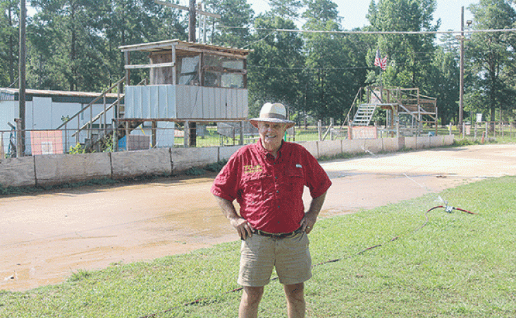 Richard Loveless is pictured as the new sprinkler system waters down the track at Turkey Creek. He is leasing the track from the village on a yearly basis with hopes of expansion. (Gazette photo by Tony Marks)