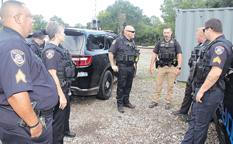 Eunice Police officers and a Union Pacific Railroad police officer discuss a railroad crossing safety session on Tuesday morning at the railroad site off La. 13. From left, are Sgt. Sebastien Noel, Officer Chase Godeaux, Officer Corina Schexneider, Lt. Donnie Thibodeaux, Union Pacific Railroad senior special agent Joshua Guillory, Officer Bryan Wiles and Sgt. Trace Tilbury.
