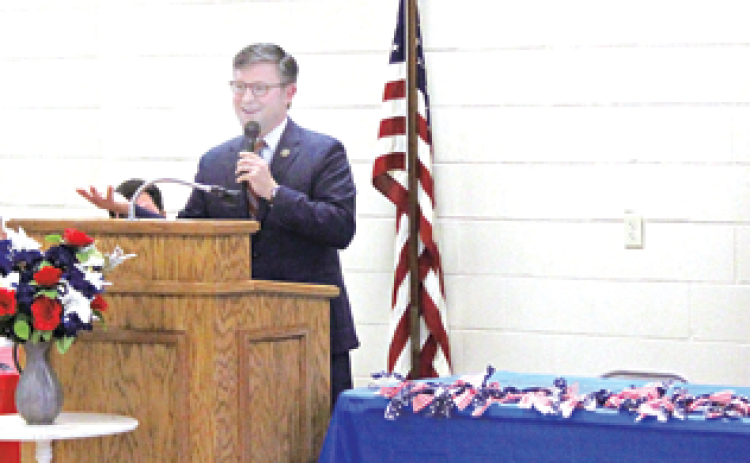 Speaking at lectern is U.S. Rep. Mike Lee at town hall meeting in in Pine Prairie on July 6. Seated, from left, are Evangeline Parish Clerk of Court Randy Deshotel, Evangeline Parish School Board President Wayne Dardeau, Pine Prairie Mayor Quint West, Pastor Kevin West of First Baptist Church Ville Platte, and Pine Prairie Council Members Tammy Buxton and Gilbert Bordelon. (Photo by Tony Marks/Ville Platte Gazette)