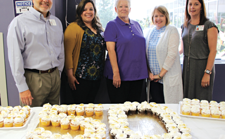 Marcella Prejean was surprised with a celebration event honoring her working at the hospital for 50 years. From left, are CEO of Acadian Medical Center Kevin Frank, Natalie Lemelle, associate chief financial officer; Prejean; Janice Jones, chief financial officer; and Julie Paul, chief nursing officer. (Photo by Myra Miller)