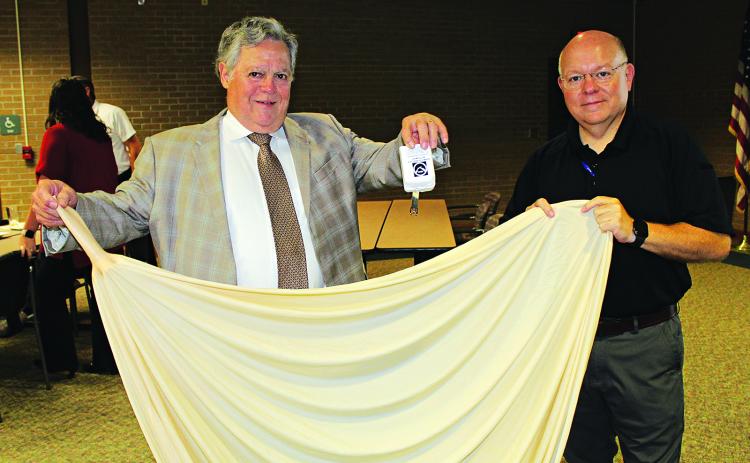 Holding up a radiosonde, a weather instrument, and a weather balloon are John Pucheu and Van Reed. (Photos by Myra Miller)