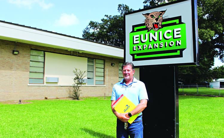 Charles Vidrine, administrator at Eunice Expansion, stands by the new sign at the former Eunice Elementary on Monday. (Photo by Myra Miller)