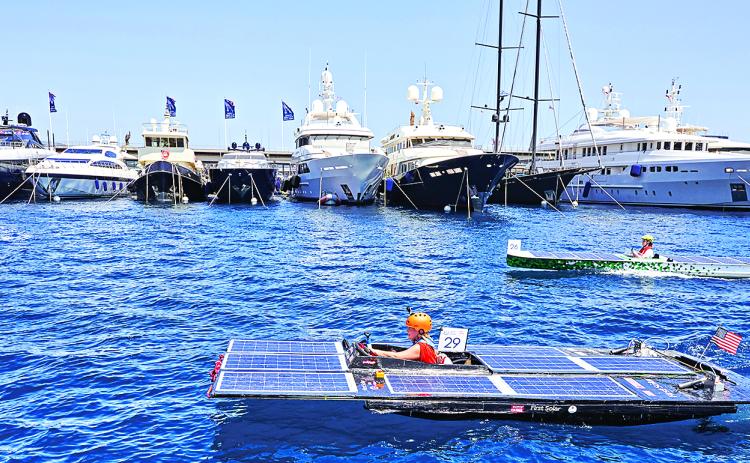A solar-powered boat designed and built by a team of UL Lafayette mechanical engineering students recently became the first from the U.S. to compete in the Monaco Energy Boat Challenge. The five-member Southern Solar team’s innovative vessel (foreground) was showcased during races, demonstrations and a presentation at the event in Monaco, on the coast of the Mediterranean Sea. (Submitted photo)