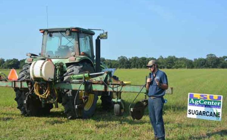 Iberia Parish sugarcane grower Taylor Blanchard displays a no-till fertilizer implement that applies fertilizer to the top of the rows to allow for more direct applications with less soil disturbance during a field day focused on sugarcane at the LSU AgCenter Iberia Research Station on July 27. (Photo by Derek Albert/LSU AgCenter)