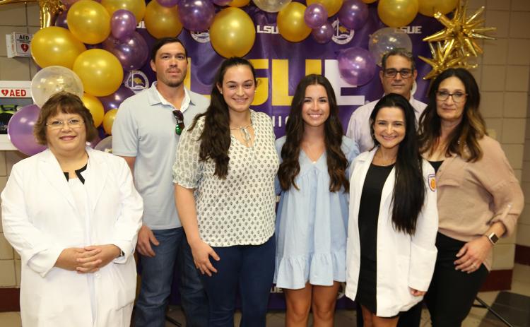 The first Amy Olivia Guidry Memorial Scholarship was awarded during the White Coat Ceremony at LSUE on Thursday. Guidry was a LSUE nursing graduate and nurse at the Lafayette General Hospital emergency room who died in July 2021. From left, are Mae Simoneaux, LSUE program director; Skee and Brittany Smith; scholarship recipient, Taylor Doughty; Chelsie Blanchard, of Ochsner Hospital Lafayette; and Wendel and Vanda Guidry, of Church Point. Brittany Smith is Guidry’s sister and the Guidrys are her parents.