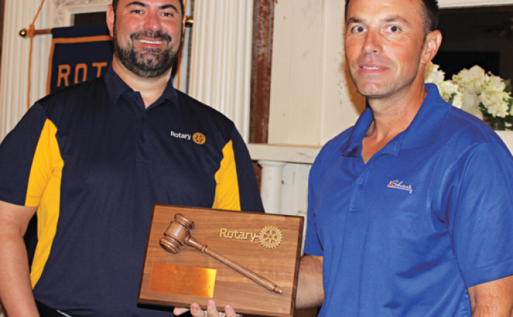 Jacob Bergeron, president of Eunice Rotary Club, presents a plaque of appreciation to past president of Rotary Club Coby Clavier. (Photo by Myra Miller)