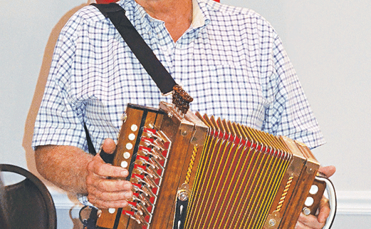 Ken Lyon presented an interesting history of the accordion to the Crowley Lions Club, telling members that the symbol of Cajun French music actually comes from Germany. (Photos by Steve Bandy/Crowley Post-Signal)
