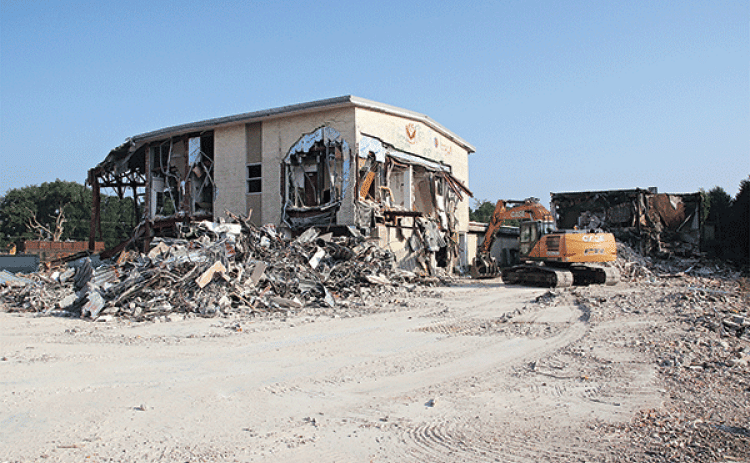 The old Moosa Memorial Hospital continues to disappear as demolition work progresses. St. Landry Parish President Jessie Bellard explained at a Parish Council meeting Wednesday the next big piece of the building to be razed is the two-story section. A building with about 13,000 square feet is to be retained and refurbished for office space, he said. Metal extracted from the building is being sold to recyclers and other material is being  used on parish roads, Bellard said. The cleared property will be aucti