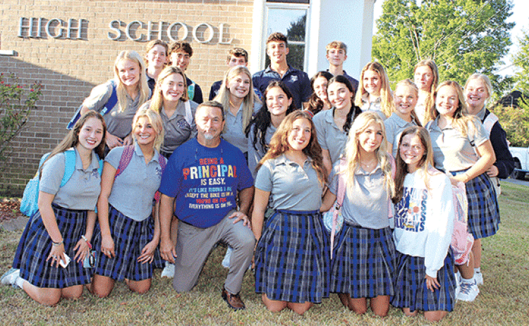 Mitchell Fontenot, principal at St. Edmund Catholic School, is surrounded by seniors on the first day of school Wednesday. Fontenot had been principal at Eunice High School. (Photo by Myra Miller)