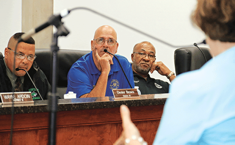 St. Landry Parish Council members, from left, Dexter Brown, Timmy Lejeune and Jimmie Edwards listen to human resource expert Becky Rogers at a special meeting Wednesday. The Council tied 6-6 on whether to hire Rogers and another vote is set for this Wednesday’s meeting. If hired, Rogers would investigate firings by Parish President Jessie Bellard. (Photo by Harlan Kirgan)