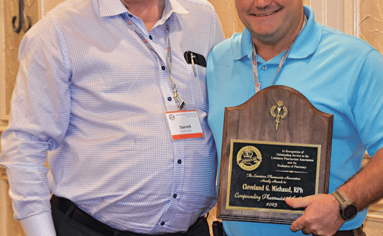 Cleveland “Glen” Michaud, right, is presented the Compounding Pharmacist of the Year Award by Darrell Granger. (Submitted photo)