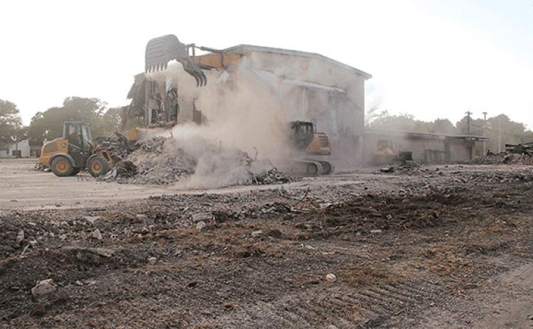 The dust was flying as heavy equipment worked on the demolition of the old Moosa Memorial Hospital on Tuesday afternoon. By Thursday, the central two-story portion of the building was left standing alone. Another portion of the structure remained on the north side. St. Landry Parish Government crews are doing the demolition. (Photo by Harlan Kirgan)