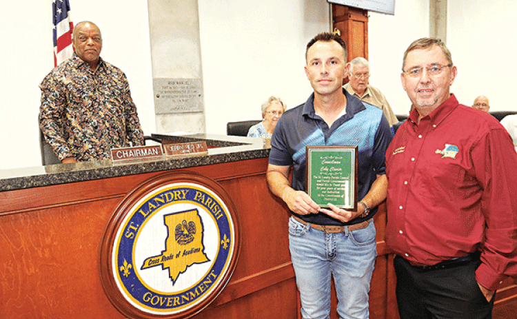 Former St. Landry Parish Council member representing District 13 Coby Clavier holds a plaque recognizing his service at Wednesday’s Parish Council meeting. From left, are Jerry Red, Council chairman; Vivian Olivier, Council member; Clavier; Wayne Ardoin, Council member; Jessie Bellard, parish president; and Timmy Lejeune, Council member. Clavier was elected to two terms, but resigned recently citing conflicts with his job. (Photo by Harlan Kirgan)