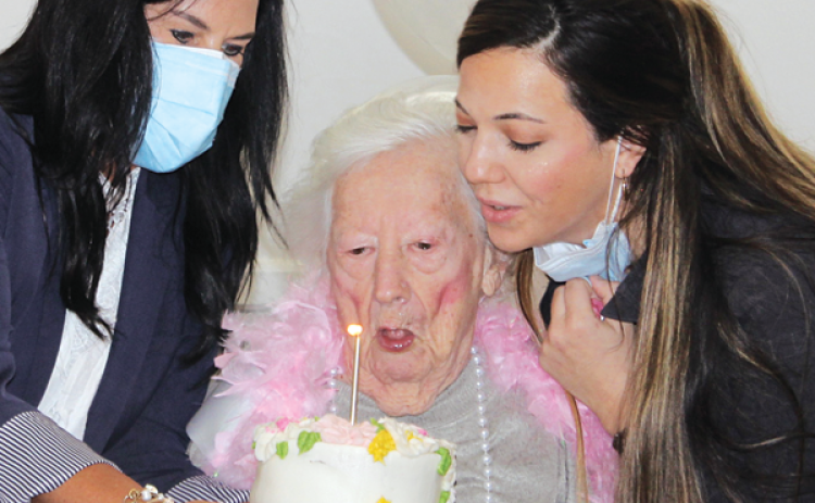 Mary Tate Collier, a resident at Eunice Manor, celebrated her 100th birthday with a party Friday. Collier and her late sister, Ethel Tate, owned and managed Mary Collier Fashions from 1966 until 1984. Blowing out her candle on her birthday cake with her are Nickie Toups, administrator, left, and Lauren Lirette, minimum data set nurse at Eunice Manor.