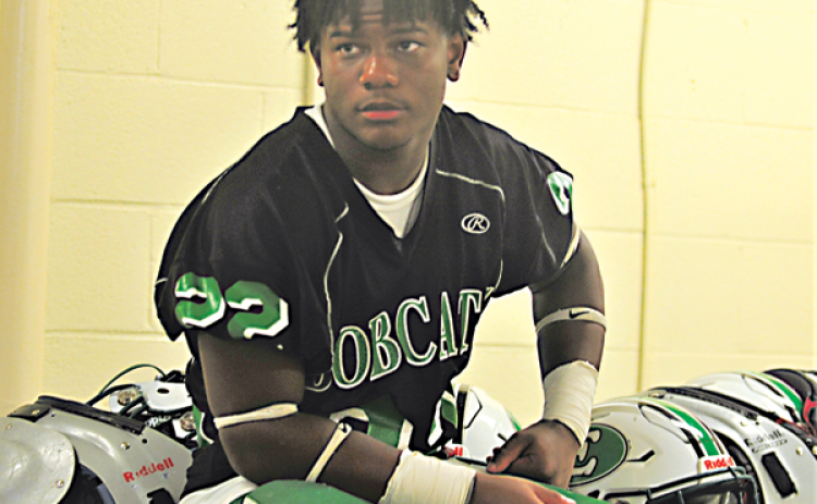 Eunice High’s Lathan Kennedy sits in the locker room as it storms outside at Clark Field in Lafayette. (Photo by Tom Dodge)
