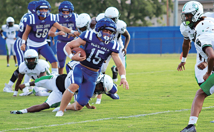 St. Edmund quarterback Kane West runs with the ball during a scrimmage with Peabody on Aug. 22. Football season is starting today and Friday for the Blue Jays and Eunice High Bobcats. Turn to Page 6A for more scrimmage photos and the annual football preview sections in today’s Eunice News. (Photo by Amy Myers)