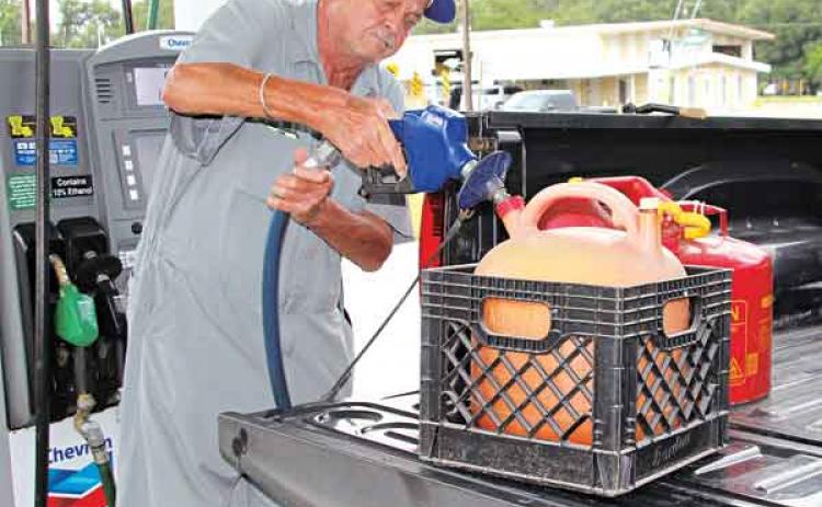 Randy Fontenot of Lanse Meg fills gas cans to run a home generator in preparation for Hurricane Ida expected on Sunday. (Photos by Myra Miller)