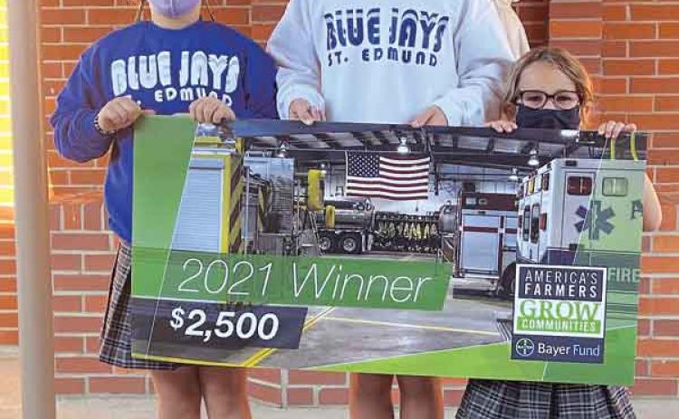 Raymond and Tammy Fruge’s granddaughters at St. Edmund proudly display a $2,500 from Bayer Fund America’s Farmers Grow Communities donation to their school. From left, are Aisley Fruge, Reese Fruge and Clara Fruge. (Submitted photo)