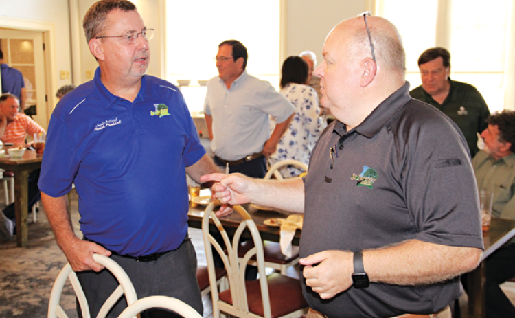 St. Landry Parish President Jessie Bellard, left, and Van Reed, parish emergency preparedness director, speak after Wednesday’s Eunice Rotary Club meeting. Bellard spoke at the meeting. At far right in the background is retired judge Ellis Daigle. (Photo by Harlan Kirgan)