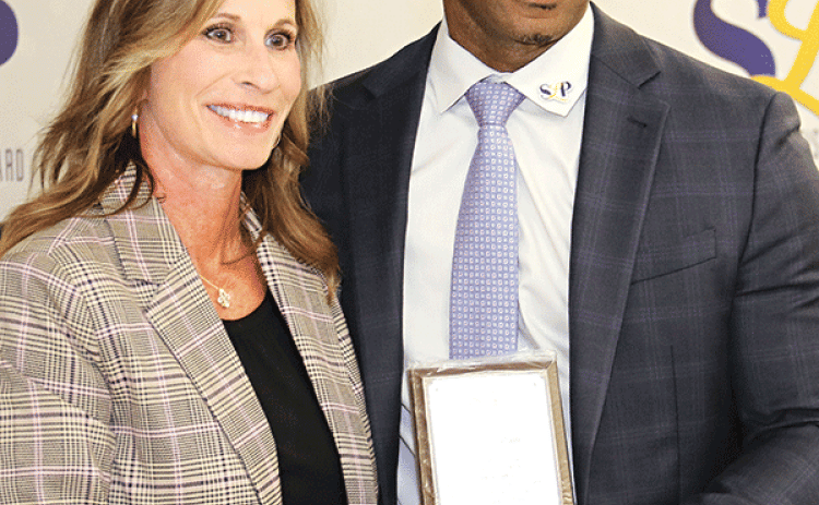 Karen Vidrine is among the retirees from the St. Landry Parish School District recognized at Thursday’s meeting in Opelousas. Vidrine retired as principal at the Magnet Academy for Cultural Arts in Opelousas after 32 years of service. Also honored, but not present, was Sharon Dietz, a teacher at Eunice Junior High School, who retired with 28 years of service. Vidrine is with Superintendent Milton Batiste III.(Photo by Harlan Kirgan)