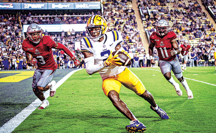 LSU’s junior receiver Kyren Lacy rushes toward the end zone as Nicholls players Laurence Sullivan Jr., No. 3, and Quinton Sharkey, No. 11, pursue in Saturday’s game in Tiger Stadium. LSU won 44-21. (Photos by Dwight Jodon)
