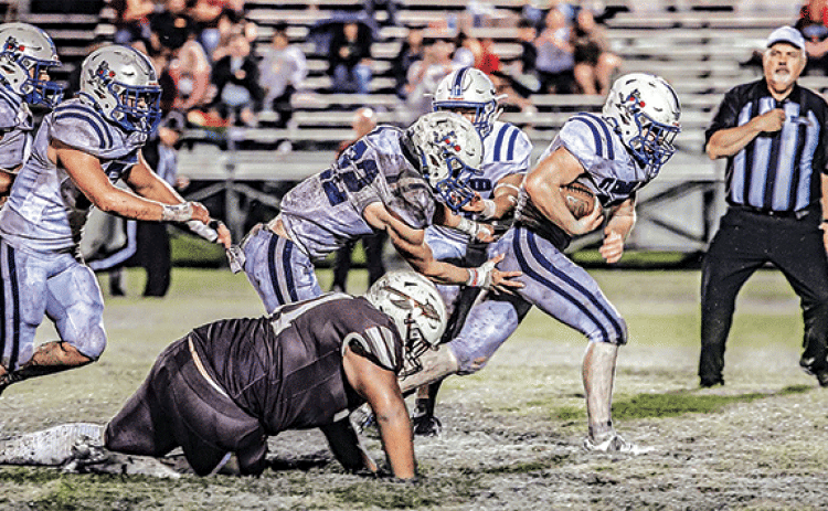 Blue Jay running back Henry Summerlin races through the Elton defense on the way to a 45-15 victory on a muddy field. (Photo by Dwight Jodon)
