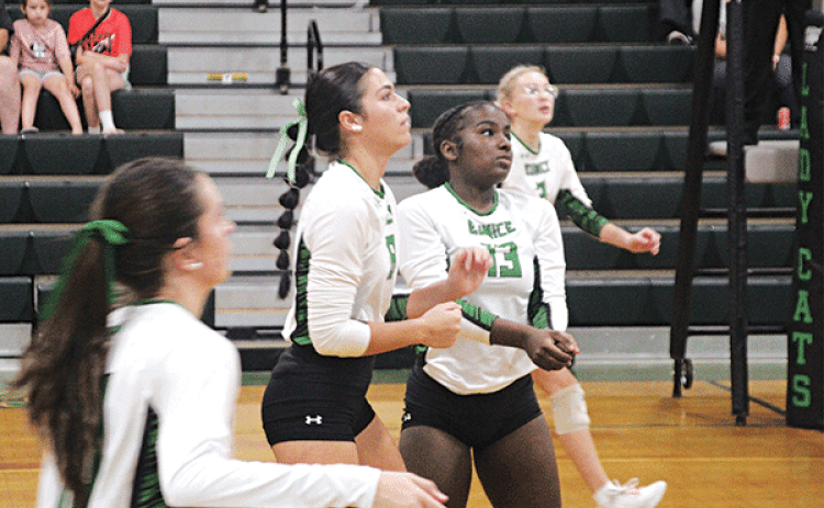 Sophomore setter Cayli Lemelle, in the photo at left, during the Eunice High tournament against Lafayette Renaissance Charter Academy on Sept. 7. Photo at right shows, from left Brooklyn Darbonne, Cayli Lemelle and Ava Grace Brown. The player at left is not identified.. (Photo by Rhett Manuel)