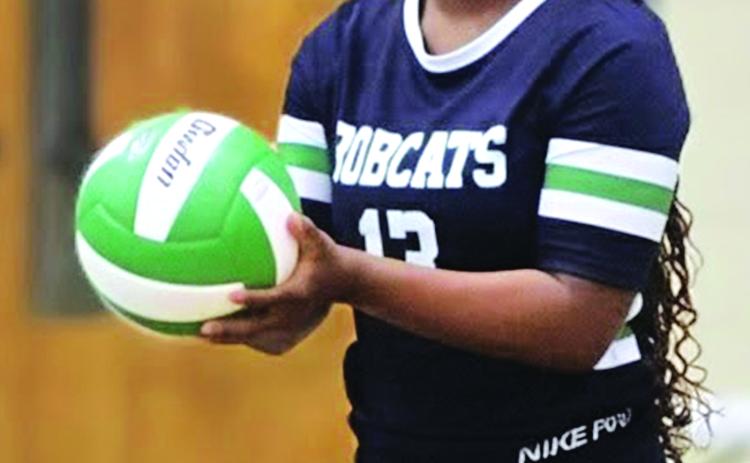 Junior Cayli Lemelle sets and serves the ball. (Photo by Rhett Manuel)